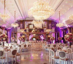 Luxurious dinner hall with large crystal chandeliers hanging from the ceiling